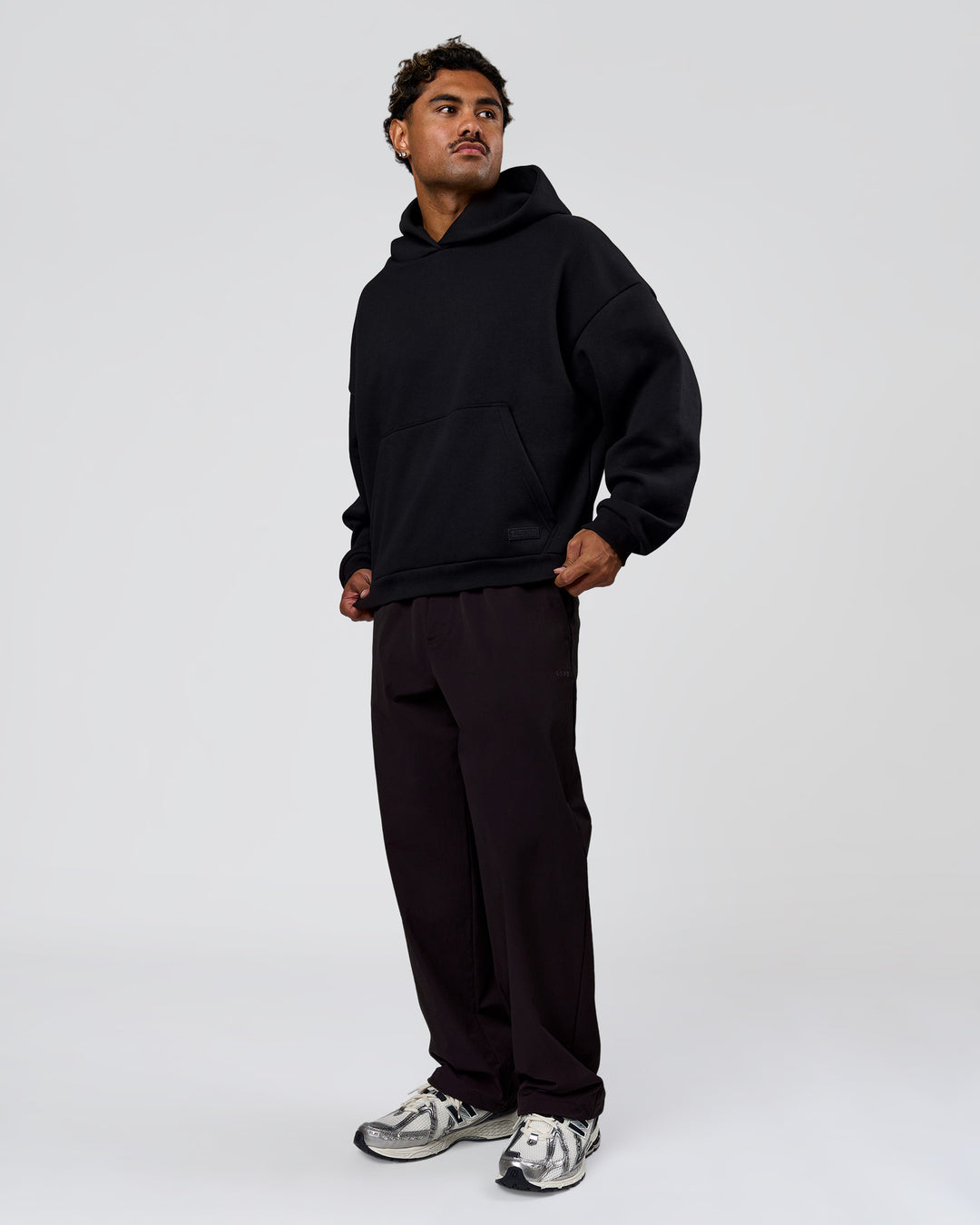Man wearing Tonal Legacy Boxy Hoodie - Black-Black | Model:Xav | Size:L - view 18