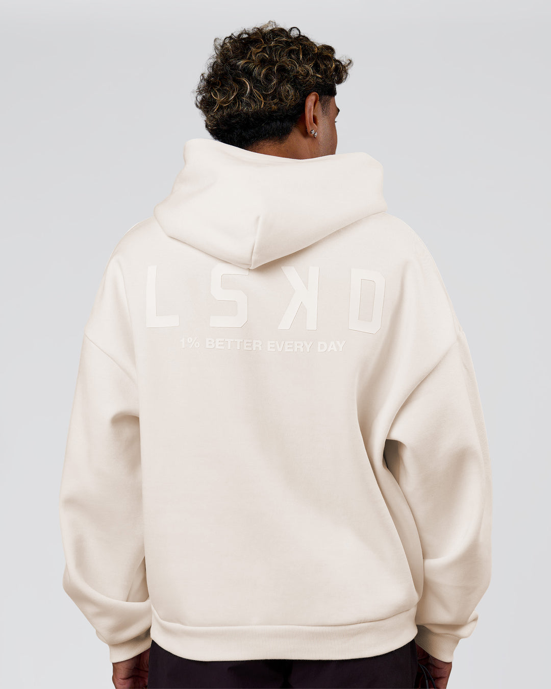Man wearing Tonal Legacy Boxy Hoodie - Off White-Off White | Model:Xav | Size:L - view 2