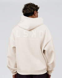 Man wearing Tonal Legacy Boxy Hoodie - Off White-Off White | Model:Xav | Size:L | Thumbnail Index: 1