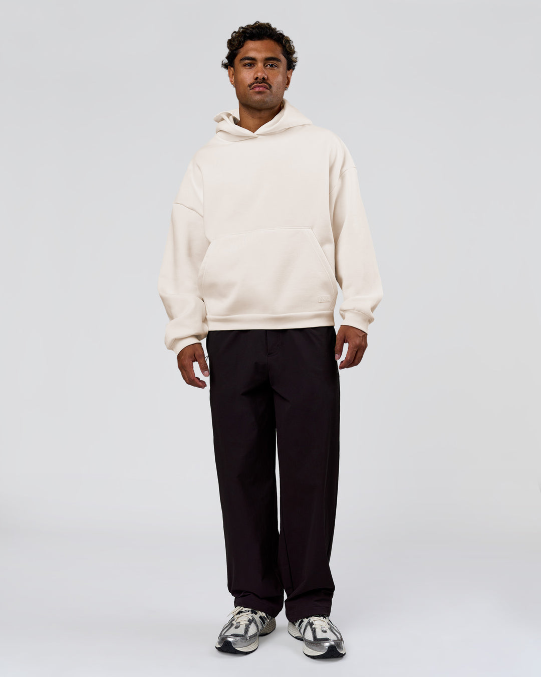 Man wearing Tonal Legacy Boxy Hoodie - Off White-Off White | Model:Xav | Size:L - view 8