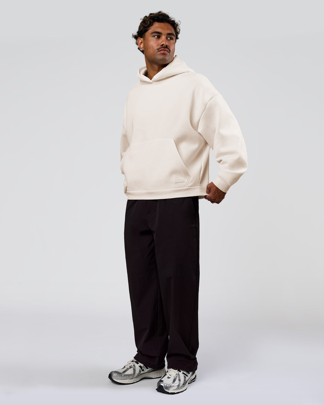 Man wearing Tonal Legacy Boxy Hoodie - Off White-Off White | Model:Xav | Size:L - view 11