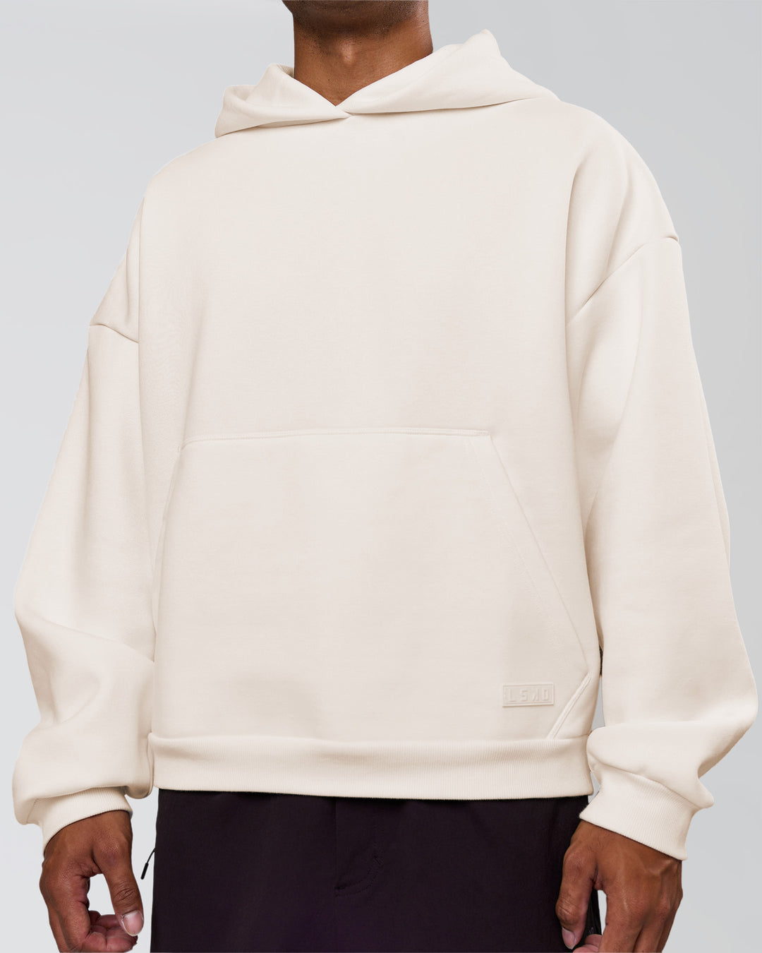 Man wearing Tonal Legacy Boxy Hoodie - Off White-Off White | Model:Xav | Size:L - view 13