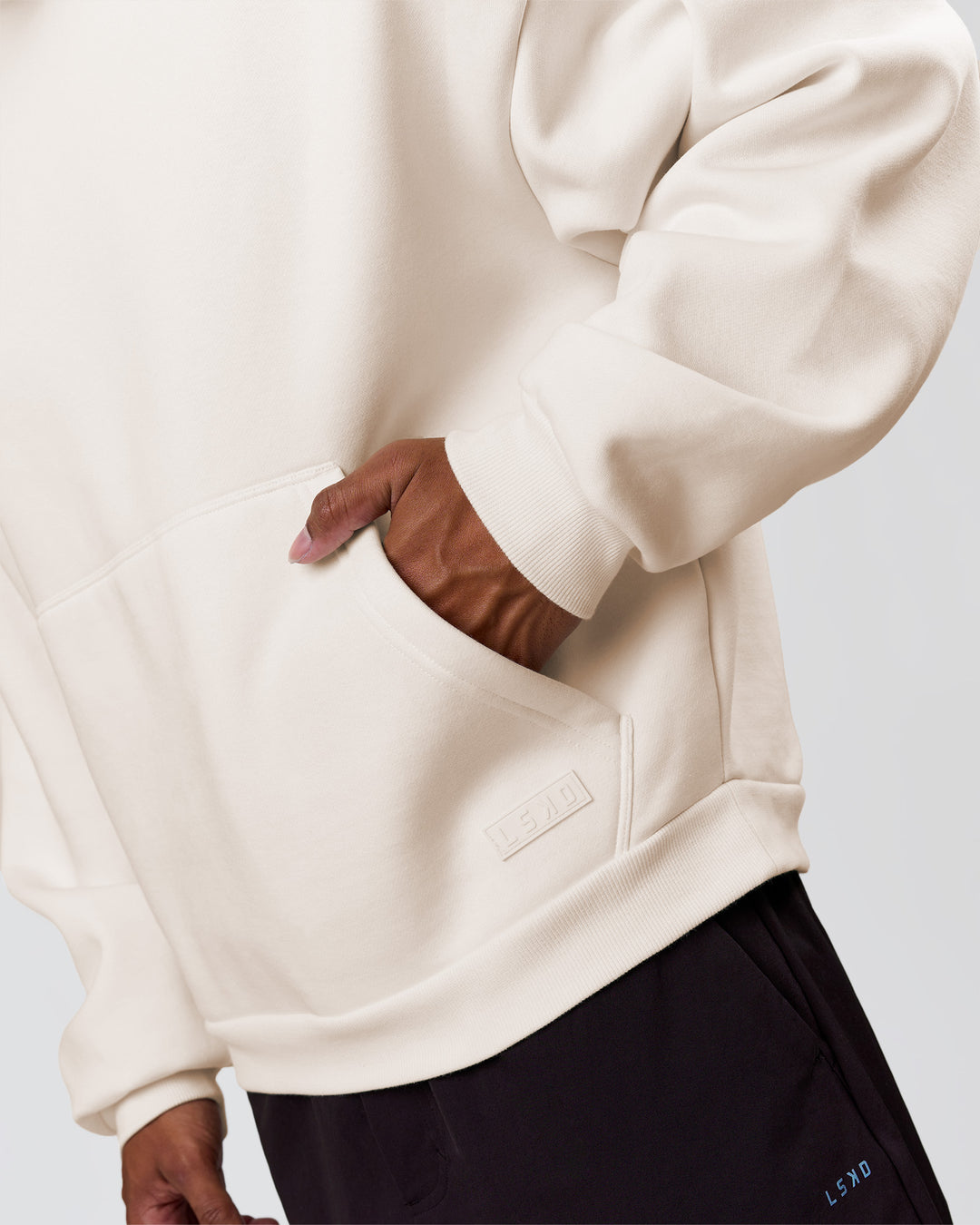 Man wearing Tonal Legacy Boxy Hoodie - Off White-Off White | Model:Xav | Size:L - view 15