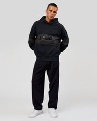 Man wearing A-Team Oversized Hoodie - Caviar-Onyx | Model:Albert | Size:M | Thumbnail Index: 10