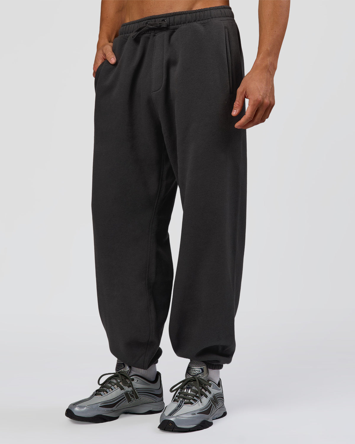 Man wearing Base Baggy Cuffed Track Pant - Onyx | Model:Albert | Size:M