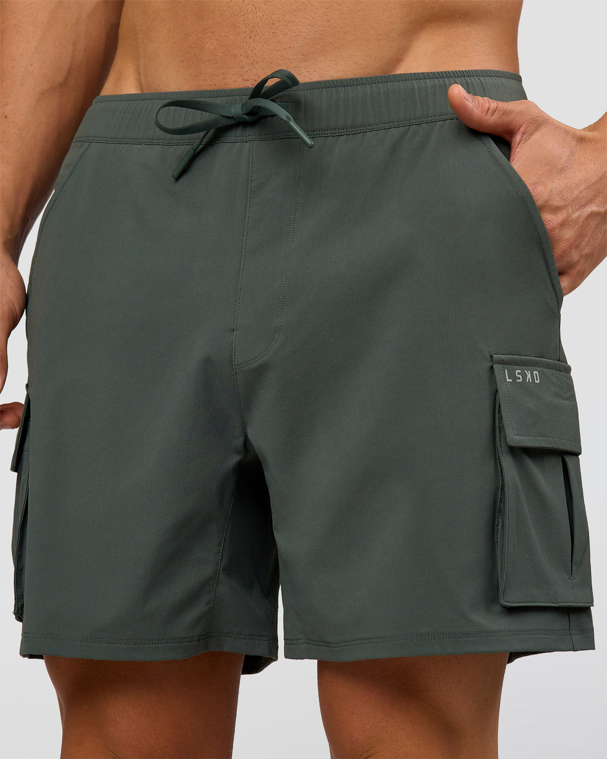 Man wearing Functional Cargo 6" Short - Carbon Green | Model:Albert | Size:M