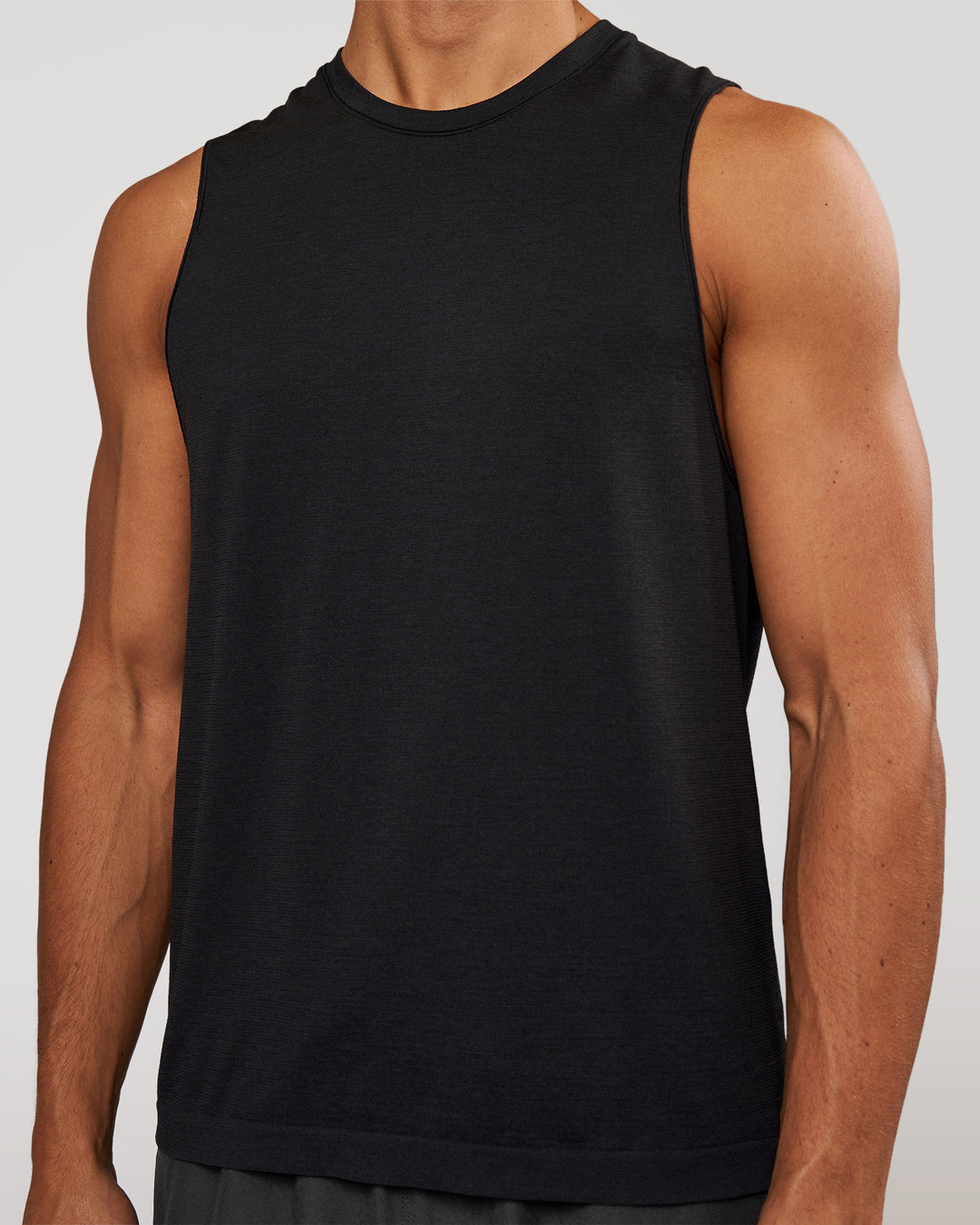 Man wearing AeroFLX+ Seamless Muscle Tank - Black Marl | Model:Albert | Size:M - view 3