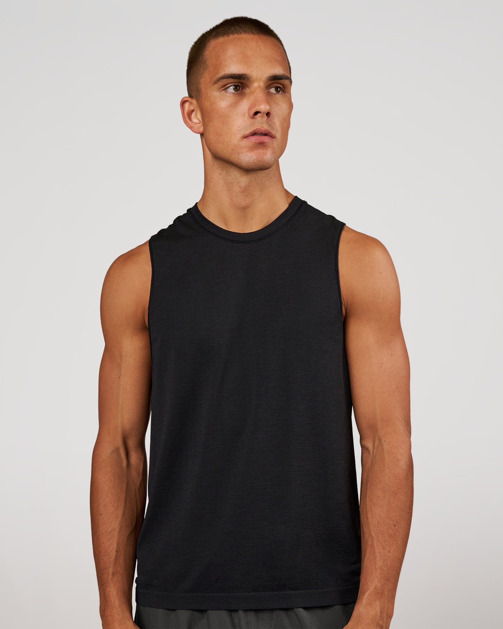 Man wearing AeroFLX+ Seamless Muscle Tank - Black Marl | Model:Albert | Size:M