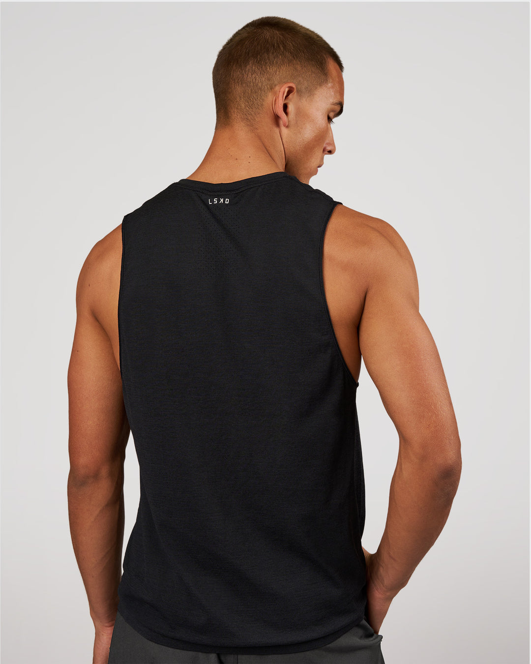 Man wearing AeroFLX+ Seamless Muscle Tank - Black Marl | Model:Albert | Size:M - view 2
