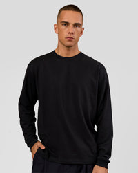 Man wearing Tonal Legacy Heavyweight Oversized LS Tee - Black-Black | Model:Albert | Size:M | Thumbnail Index: 1
