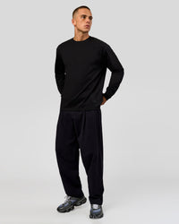 Man wearing Tonal Legacy Heavyweight Oversized LS Tee - Black-Black | Model:Albert | Size:M | Thumbnail Index: 4