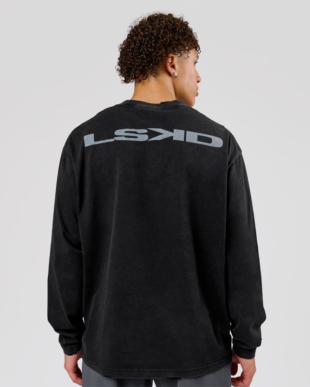 Man wearing Backline Washed Heavyweight Oversized LS Tee - Black Washed | Model:Leandro | Size:M - view 1