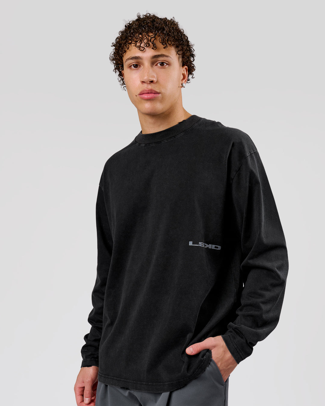 Man wearing Backline Washed Heavyweight Oversized LS Tee - Black Washed | Model:Leandro | Size:M - view 9