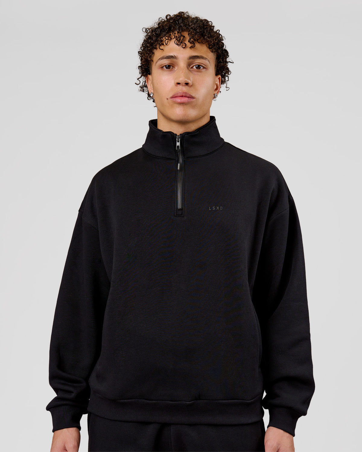 Man wearing Base Quarter Zip Sweater - Black | Model:Leandro | Size:M - view 1