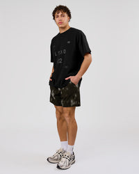 Man wearing Game Plan Heavyweight FLXCotton Oversized Tee - Black | Model:Leandro | Size:M | Thumbnail Index: 16