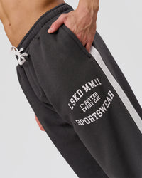 Man wearing Playbook Baggy Cuffed Track Pant - Onyx-Off White | Model:Leandro | Size:M | Thumbnail Index: 10