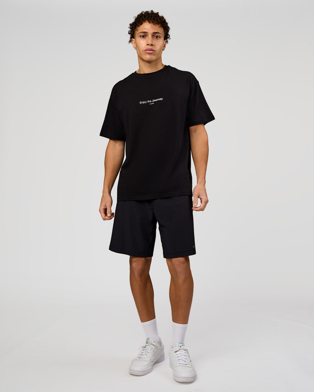 Man wearing VS1 Enjoy The Journey FLXCotton Oversize Tee - Black | Model:Leandro | Size:M - view 5
