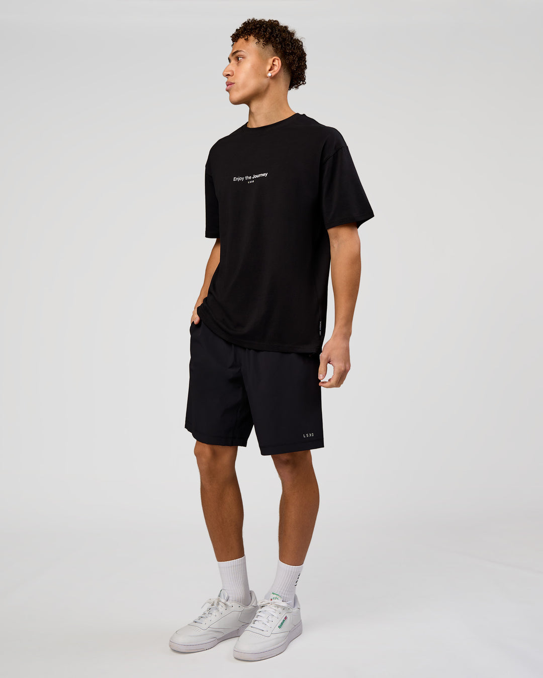 Man wearing VS1 Enjoy The Journey FLXCotton Oversize Tee - Black | Model:Leandro | Size:M - view 7