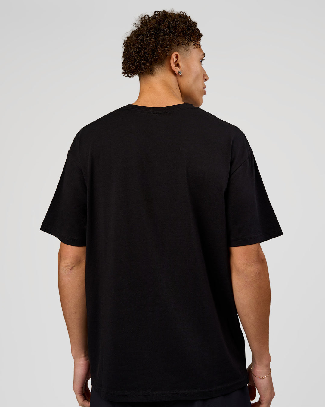 Man wearing VS1 Enjoy The Journey FLXCotton Oversize Tee - Black | Model:Leandro | Size:M - view 9