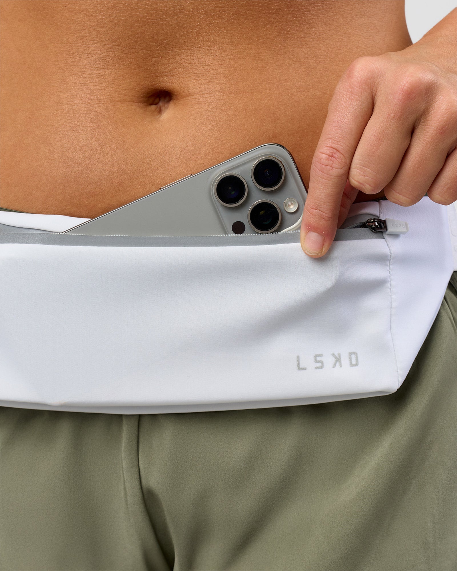 Studio image of Accelerate Run Belt - White-Reflective