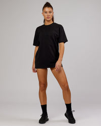 Woman wearing Unisex Stamped 2.0 Heavyweight Tee Oversize - Black | Thumbnail Index: 3