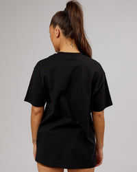 Woman wearing Unisex Stamped 2.0 Heavyweight Tee Oversize - Black | Thumbnail Index: 10