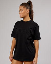 Woman wearing Unisex Stamped 2.0 Heavyweight Tee Oversize - Black | Thumbnail Index: 5