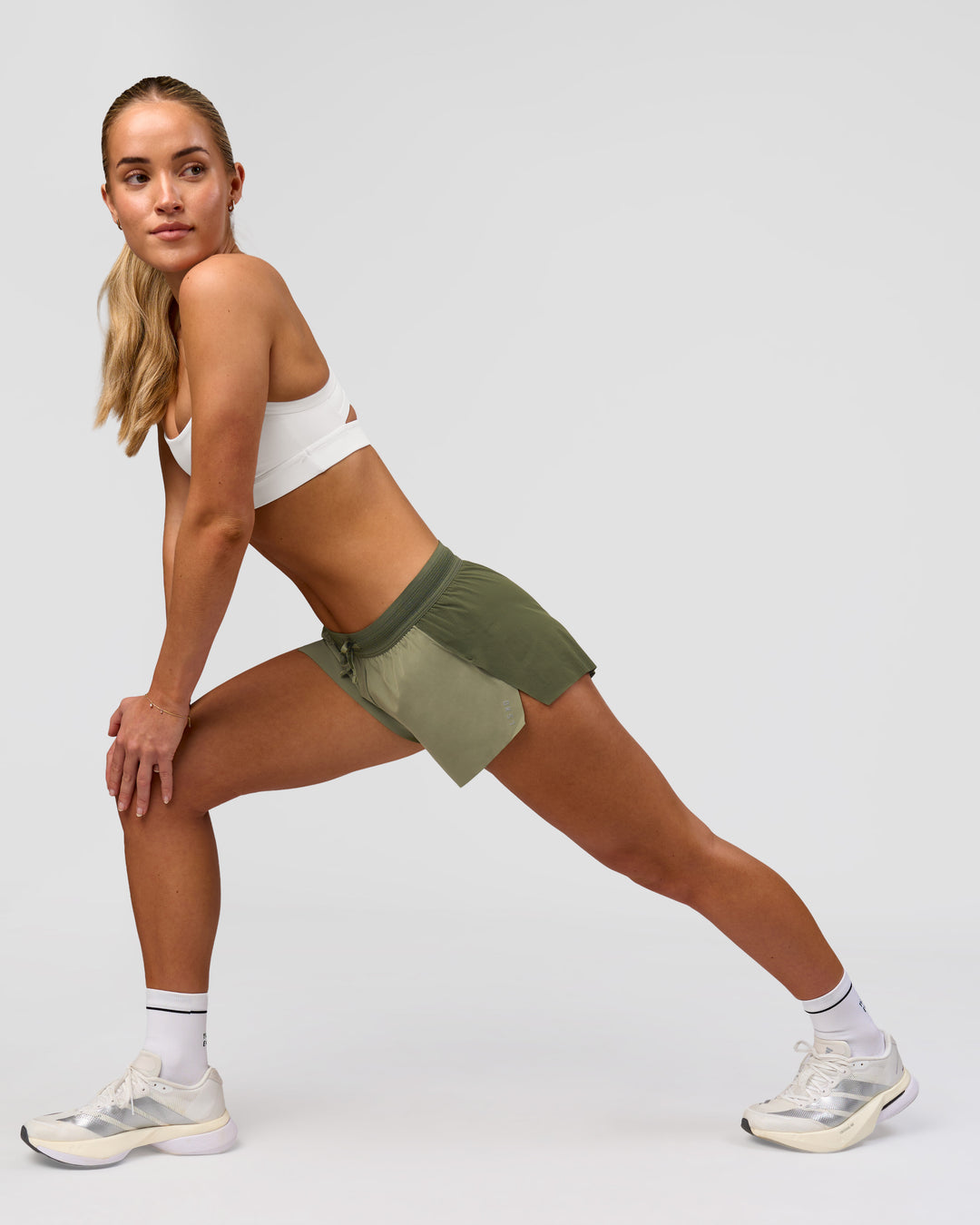 Woman wearing Accelerate 3" Mid-Rise Running Short - Pure Olive-Fog | Model:Xs | Size:ISSY - view 5