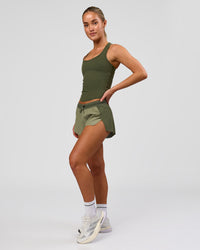 Woman wearing Accelerate 3" Mid-Rise Running Short - Pure Olive-Fog | Model:Xs | Size:ISSY | Thumbnail Index: 10