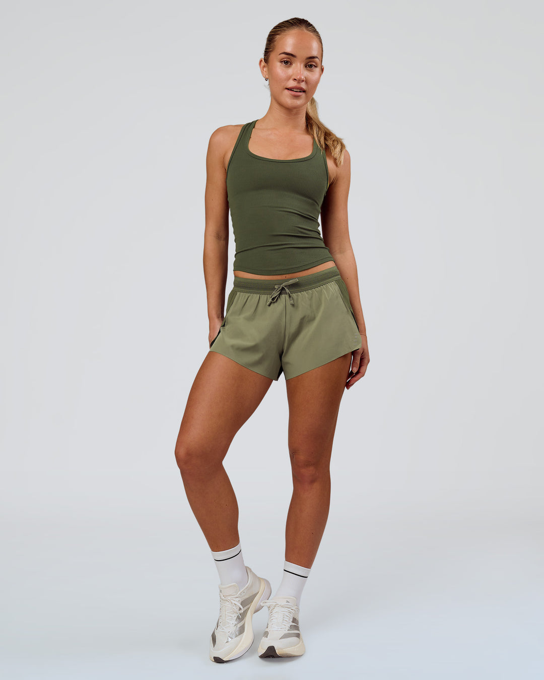 Woman wearing Accelerate 3" Mid-Rise Running Short - Pure Olive-Fog | Model:Xs | Size:ISSY - view 4
