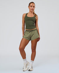Woman wearing Accelerate 3" Mid-Rise Running Short - Pure Olive-Fog | Model:Xs | Size:ISSY | Thumbnail Index: 3