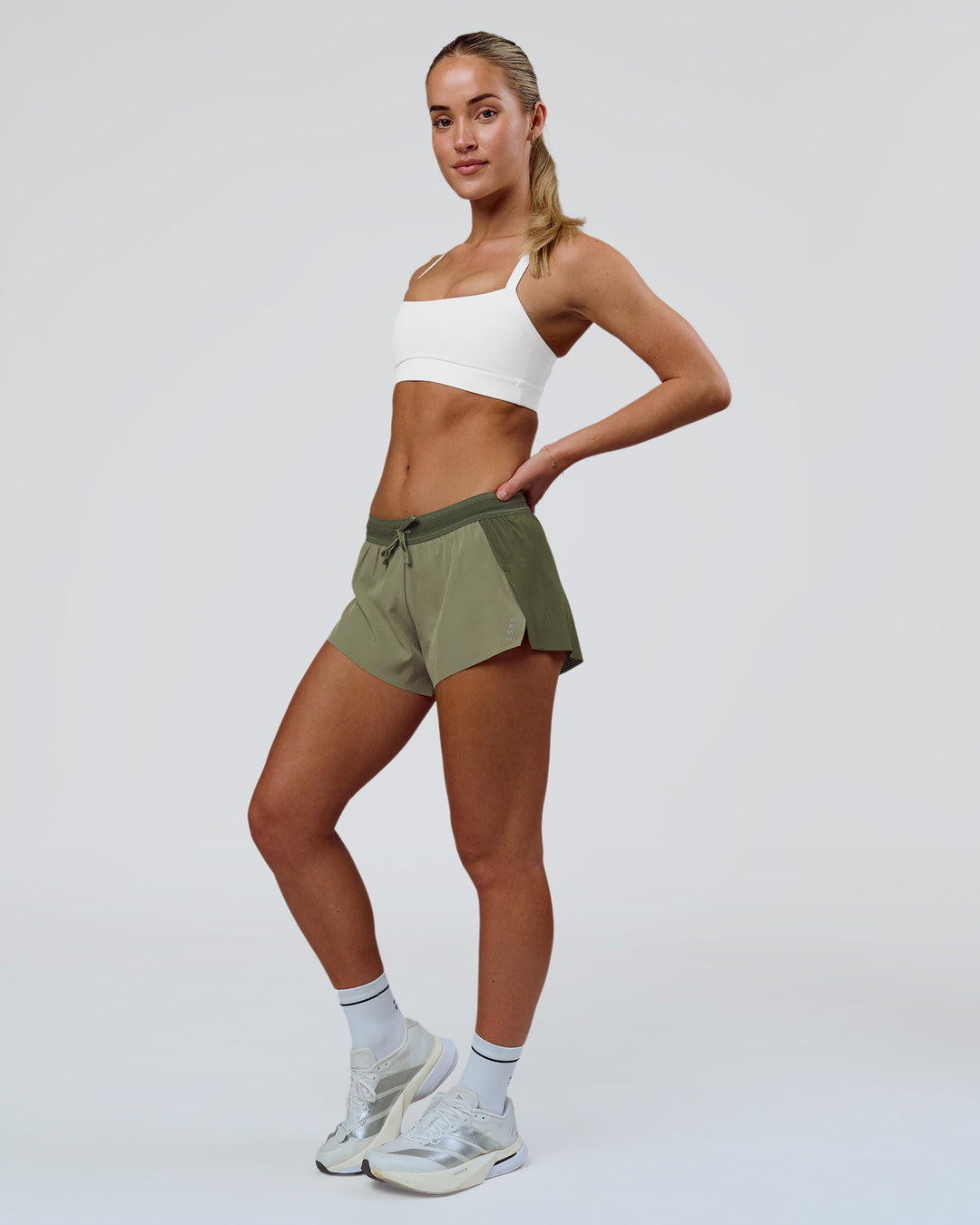 Woman wearing Accelerate 3" Mid-Rise Running Short - Pure Olive-Fog | Model:Xs | Size:ISSY - view 3