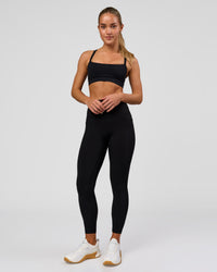 Woman wearing Fusion O.G Ultra High-Rise 7/8 Legging Pockets - Black | Model:Xs | Size:ISSY | Thumbnail Index: 1