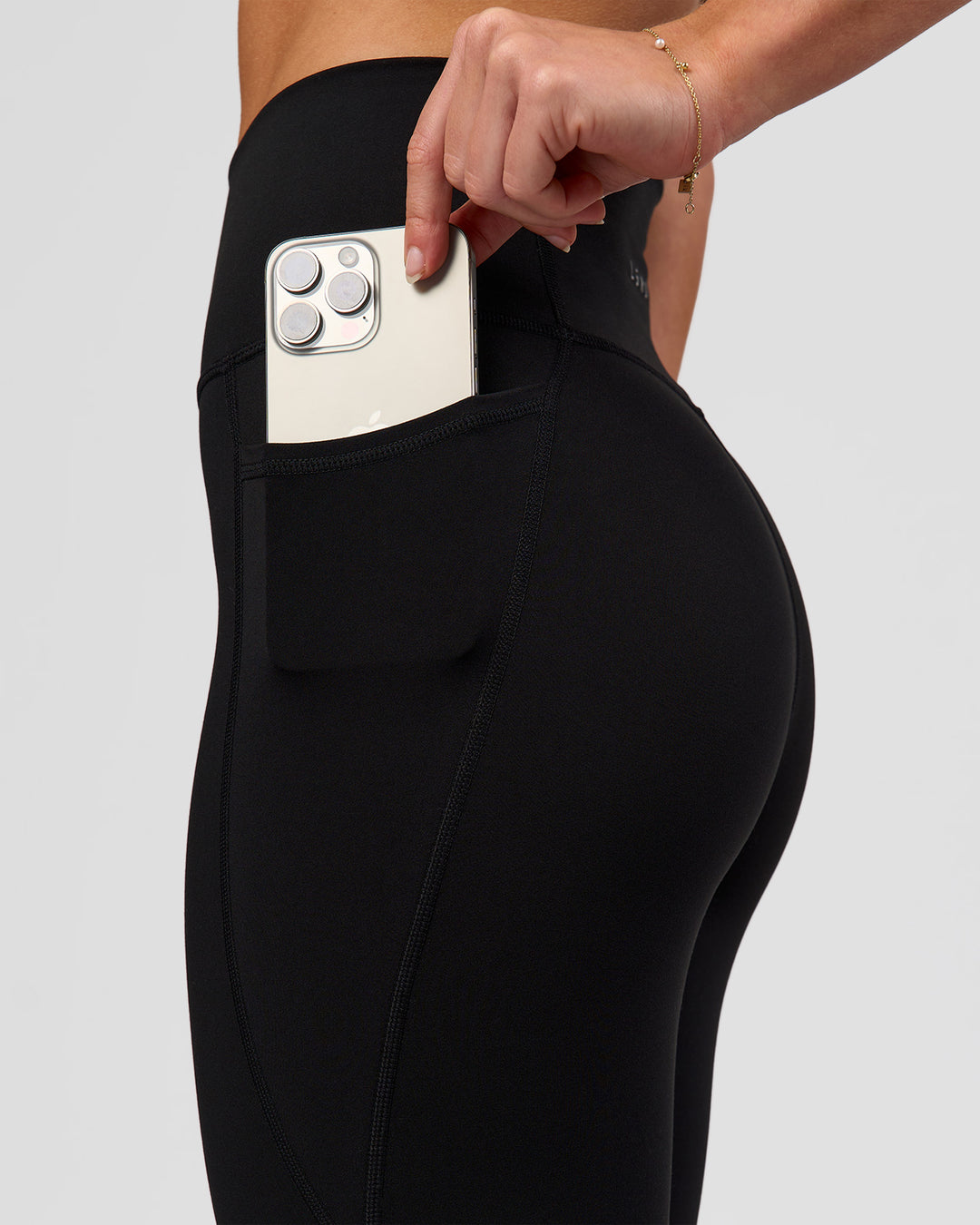 Woman wearing Fusion O.G Ultra High-Rise 7/8 Legging Pockets - Black | Model:Issy| Size:XS - view 3