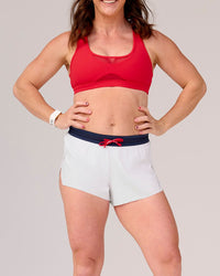 Woman wearing Accelerate 3" Mid-Rise Running Short - White-Future Navy | Model:Tia | Size:M | Thumbnail Index: 3