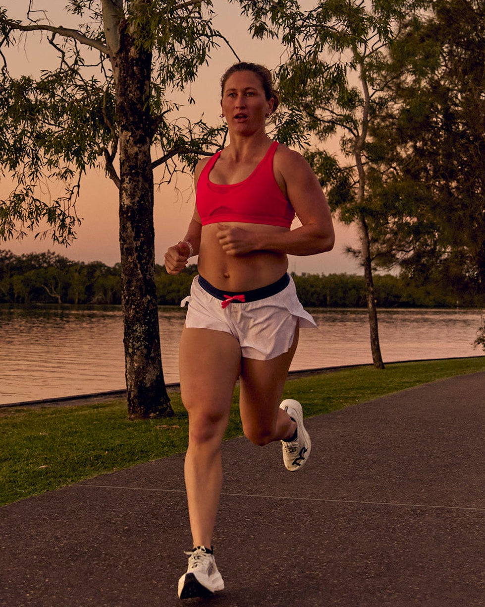 Woman wearing Accelerate 3" Mid-Rise Running Short - White-Future Navy | Model:Tia | Size:M - view 3