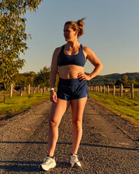 Woman wearing Tia-Clair Toomey-Orr Accelerate 3" Storage Running Short - Future Navy | Model:Tia | Size:M | Thumbnail Index: 14