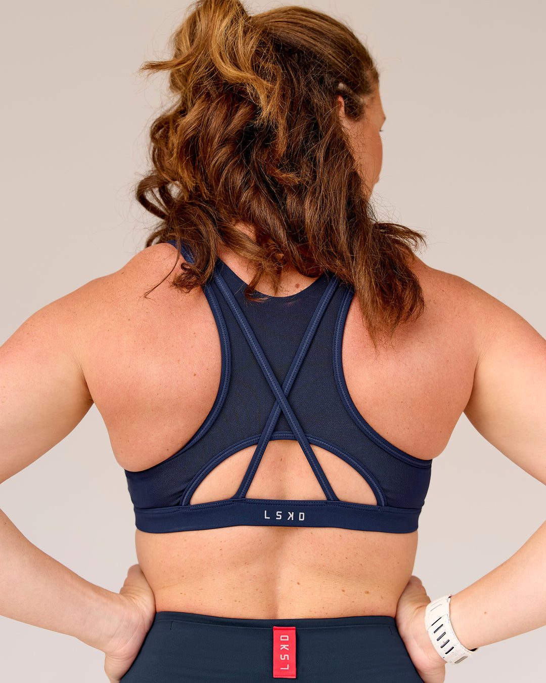 Woman wearing Unstoppable Racerback Sports Bra - Future Navy | Model:Tia | Size:M - view 6
