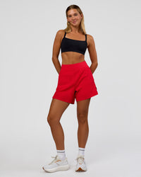 Woman wearing Challenger 5" Lined Performance Short - Scarlet | Model:Amity | Size:S | Thumbnail Index: 1