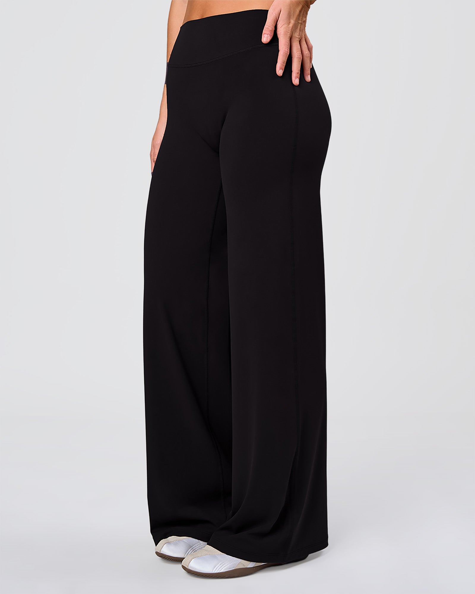 Woman wearing Elixir High-Rise Pant - Black | Model:Amity | Size:S