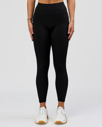 Woman wearing O.G. Fusion High-Rise Full Length Legging Pockets - Black | Model:Amity | Size:S | Thumbnail Index: 1
