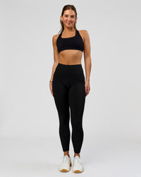 Woman wearing O.G. Fusion High-Rise Full Length Legging Pockets - Black | Model:Amity | Size:S | Thumbnail Index: 4