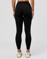 Woman wearing O.G. Fusion High-Rise Full Length Legging Pockets - Black | Model:Amity | Size:S | Thumbnail Index: 7
