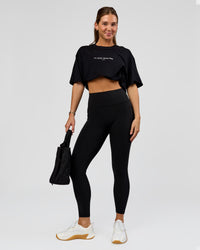 Woman wearing O.G. Fusion High-Rise Full Length Legging Pockets - Black | Model:Amity | Size:S | Thumbnail Index: 0