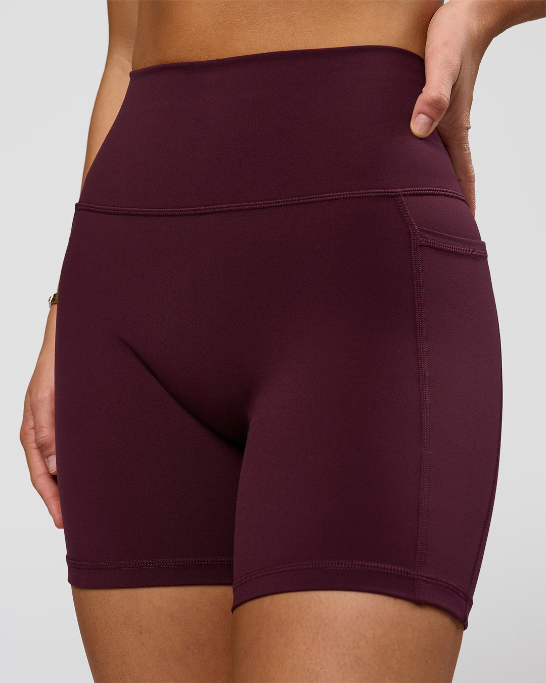 Woman wearing O.G. Fusion Ultra High-Rise 6" Short Pockets - Cherry Lacquer | Model:Amity | Size:S - view 1
