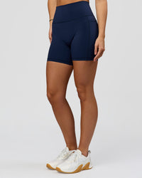 Woman wearing O.G. Fusion Ultra High-Rise 6" Short Pockets - Future Navy | Model:Amity | Size:S | Thumbnail Index: 7