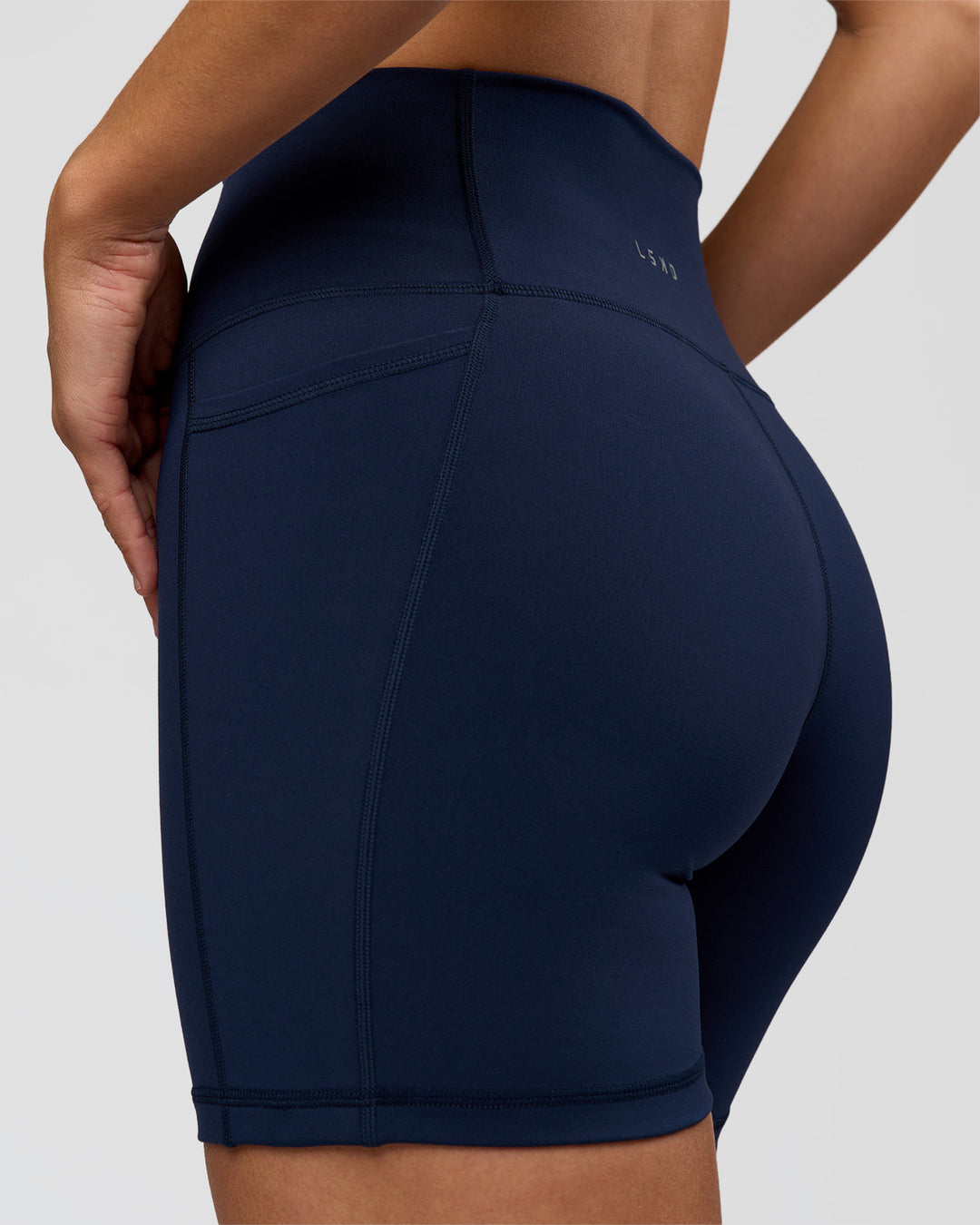 Woman wearing O.G. Fusion Ultra High-Rise 6" Short Pockets - Future Navy | Model:Amity | Size:S - view 7