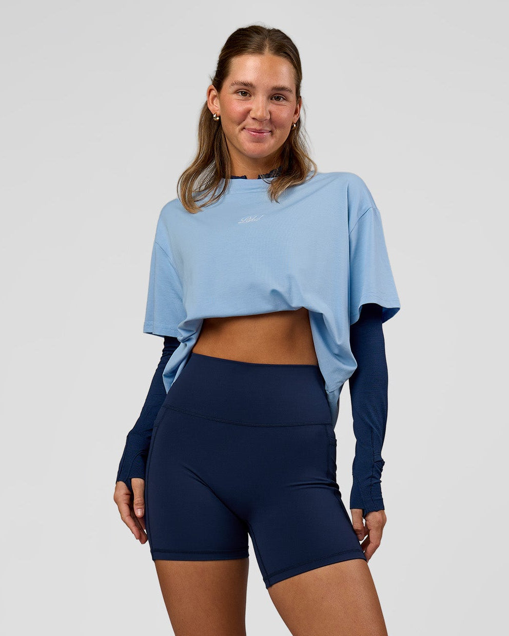Woman wearing O.G. Fusion Ultra High-Rise 6" Short Pockets - Future Navy | Model:Amity | Size:S