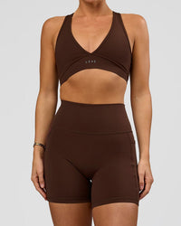Woman wearing O.G. Fusion Ultra High-Rise 6" Short Pockets - Hot Chocolate | Model:Amity | Size:S | Thumbnail Index: 0