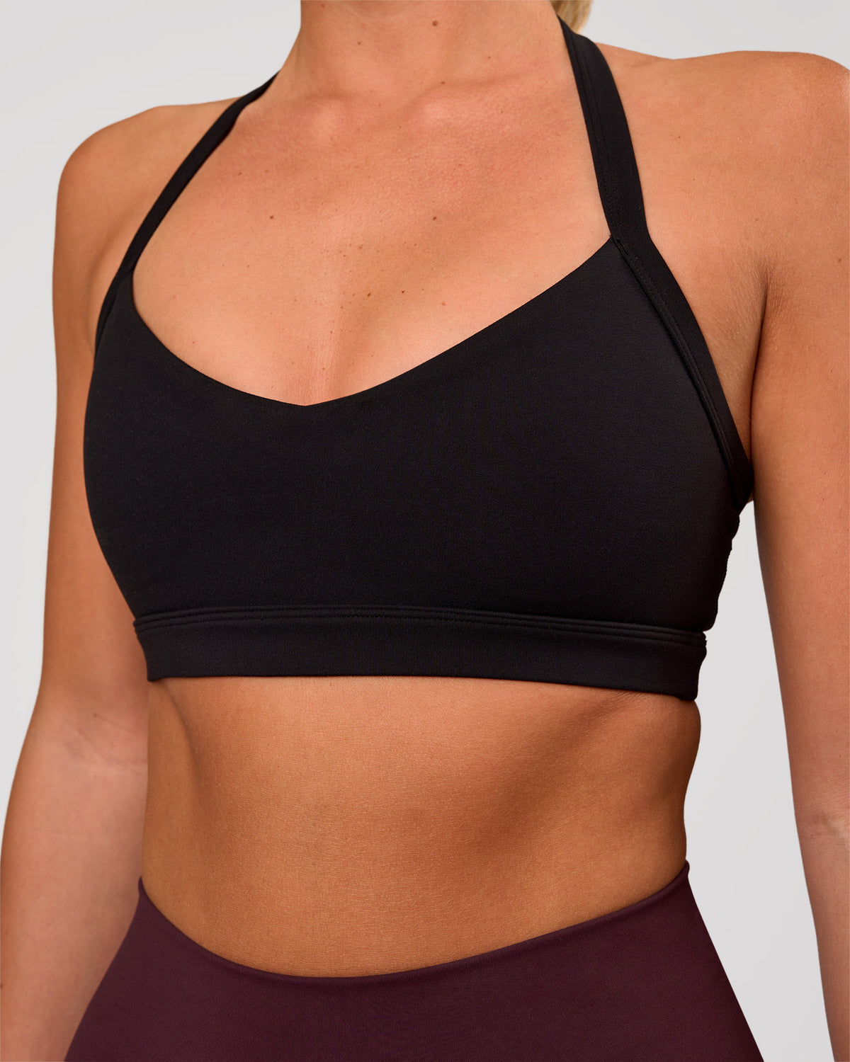 Woman wearing Unleash Sports Bra - Black | Model:Amity | Size:S